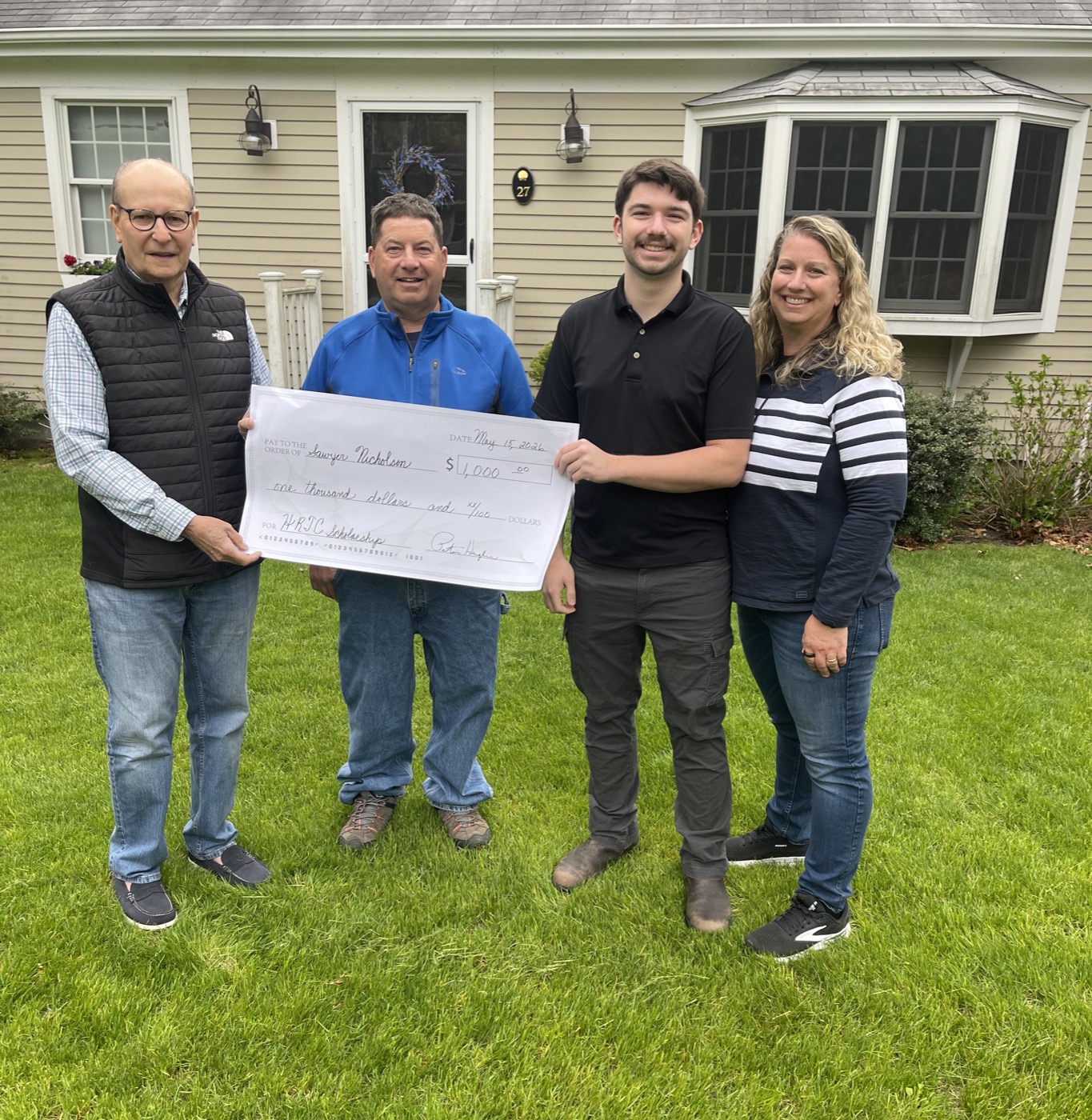 Harwich RTC Chairman Peter Hughes presents the 2026 scholarship check to Sawyer Nicholson with his parents David and Diane