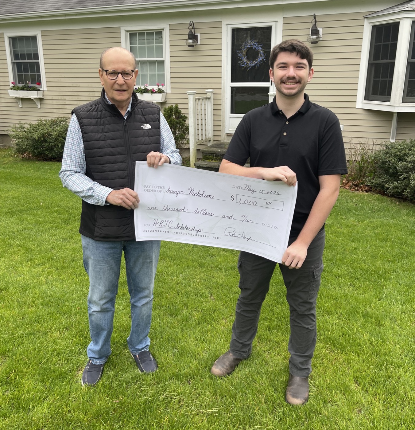 Chairman Peter Hughes presents the check to Sawyer Nicholson